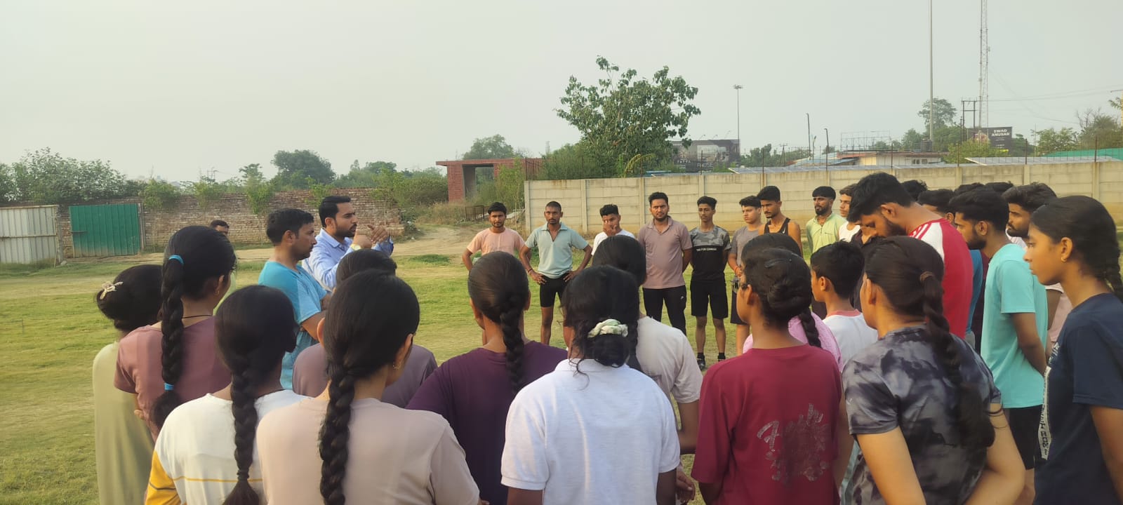 Sports PEFB founder briefing young athletes during an outdoor training session